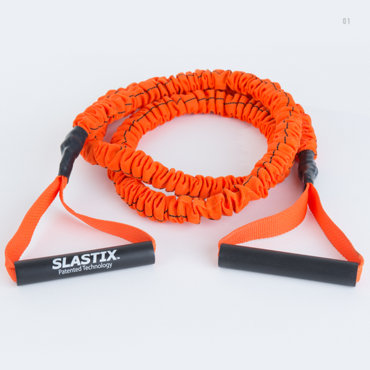 An orange Slastix with black handles and black connectors, coiled on a white background. The left handle is extended and shows the brand name 'SLASTIX' in white text.