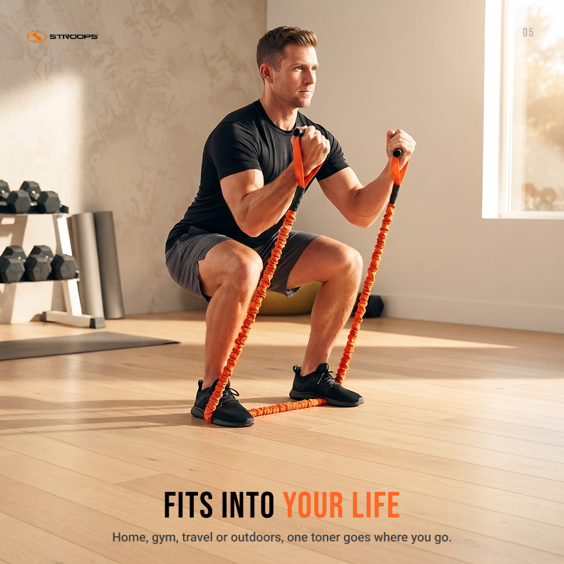 A man in a black t-shirt and gray shorts performs a squat while using an orange and black resistance band with handles in a bright, modern home gym. The STROOPS brand logo is visible in the top left, and promotional text is at the bottom.