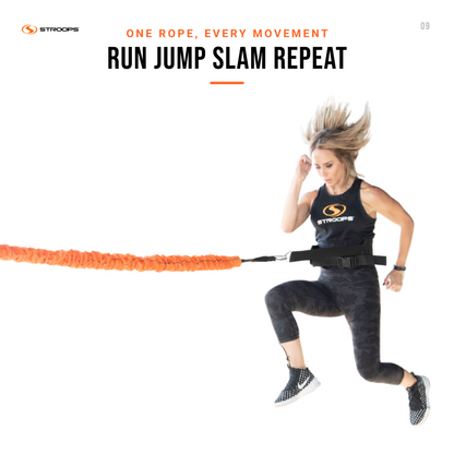 A woman in athletic wear runs while wearing a black STROOPS branded tank top and leggings, with an orange resistance band attached to her waist. The image has a white background with promotional text at the top reading 'ONE ROPE, EVERY MOVEMENT RUN JUMP SLAM REPEAT' and the STROOPS logo.