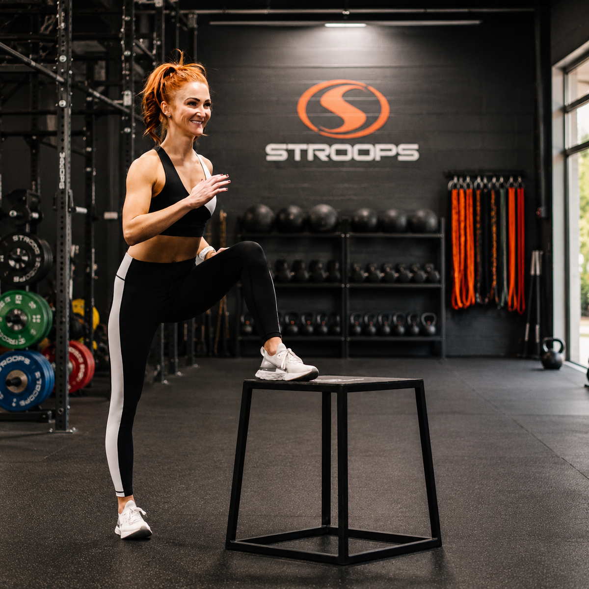 Woman exercising in a gym with 'STROOPS' branding in the background