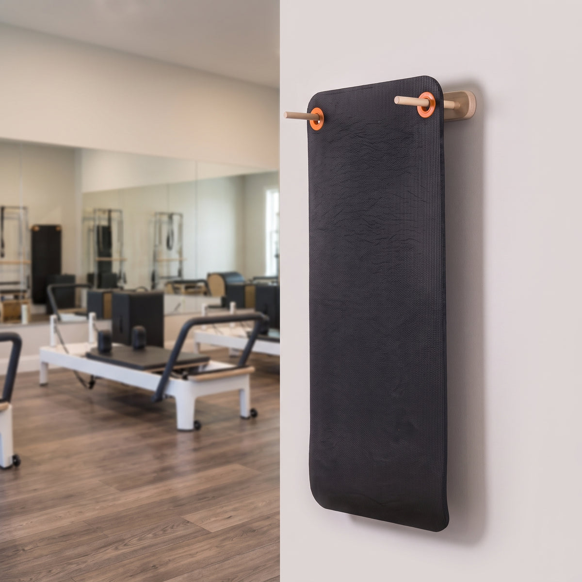 Wood Adjustable Mat Rack organizing mats in a clean Pilates or yoga studio.