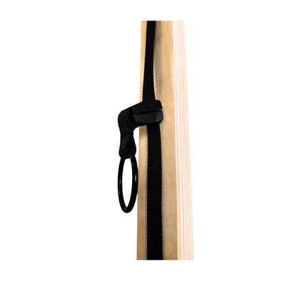 Black strap with a clip attached to a wooden surface on a white background