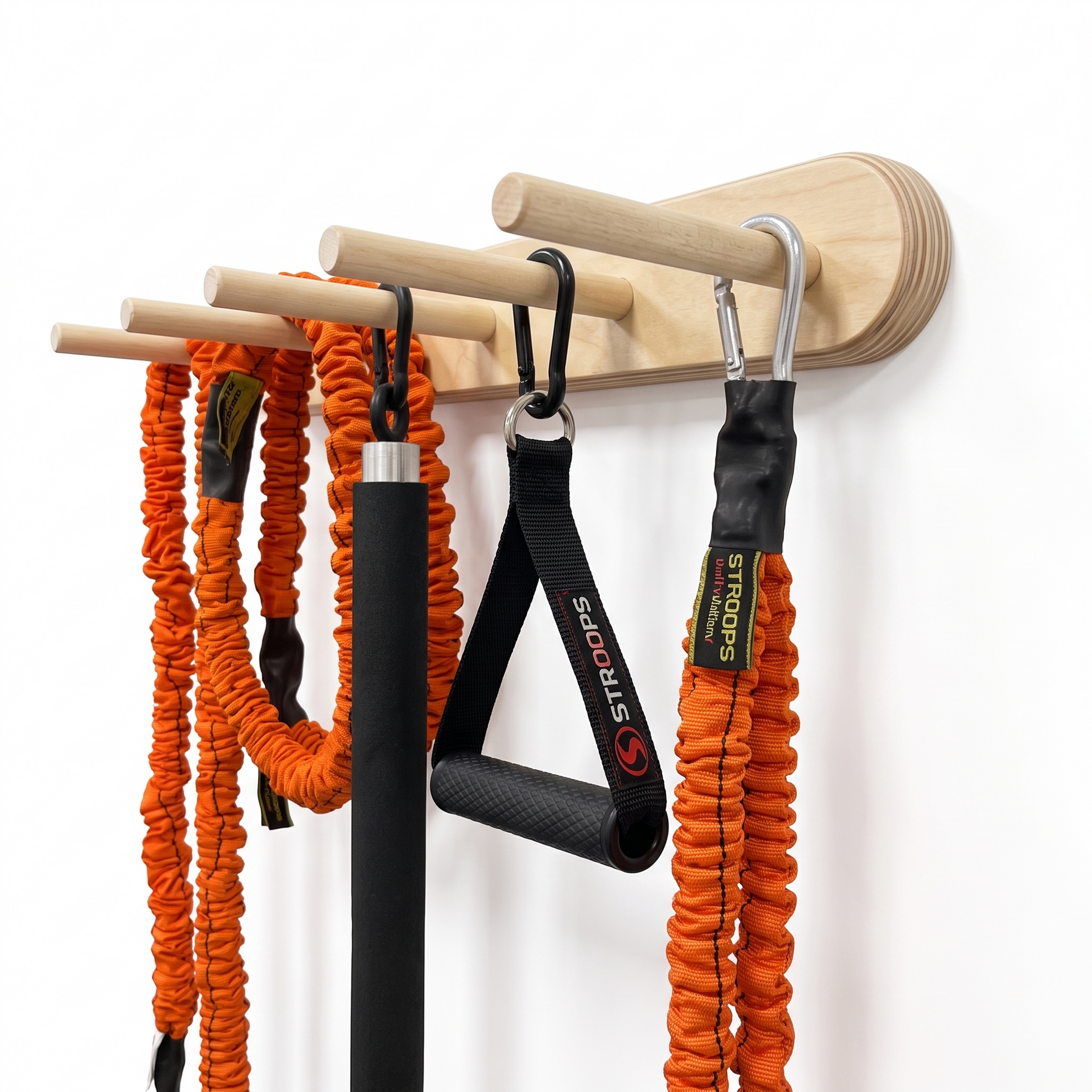 A wall-mounted wooden resistance tube holder with natural wood dowels, shown holding several fitness resistance tubes and black carabiners against a plain white wall.