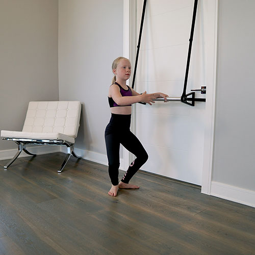 Stroops Athlete child doing barre exercise at home