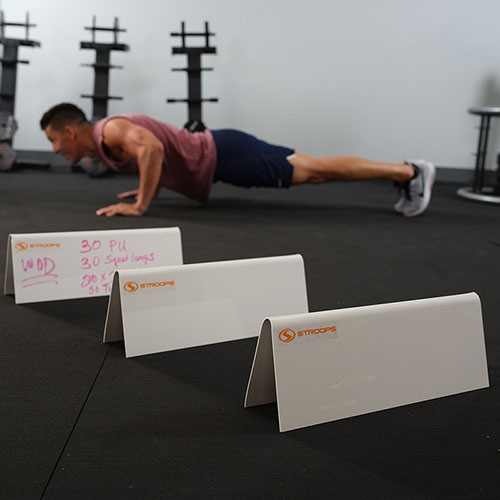 Stroops athlete doing workout with circuit written on hurdles