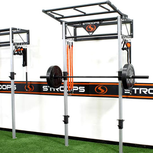 Stroops performance station set up as a squat rack with Barbell and weights in studio gym