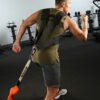 Stroops trainer doing resisted sprints with Shoulder Harness behind view