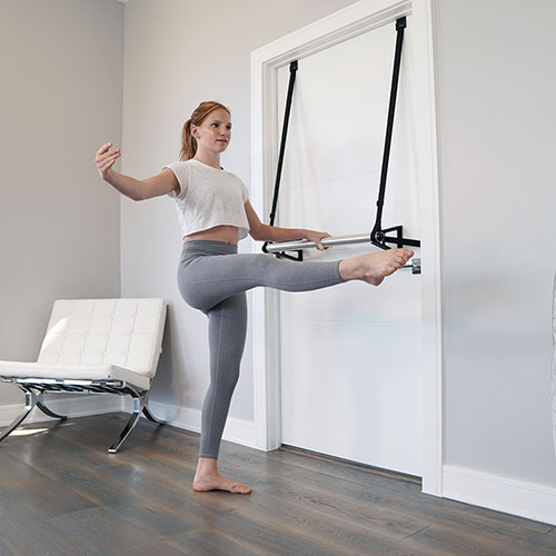 Stroops athlete teenager doing barre exercise at home