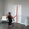 Stroops trainer Aly doing jump lunges with Universal Swivel Belt and Slastix
