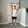 Stroops trainer James doing overhead press with Fit Stik Pro and Slastix