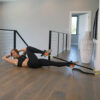 Stroops trainer Melissa doing bicycle crunches with Foot Strap and black Slastix