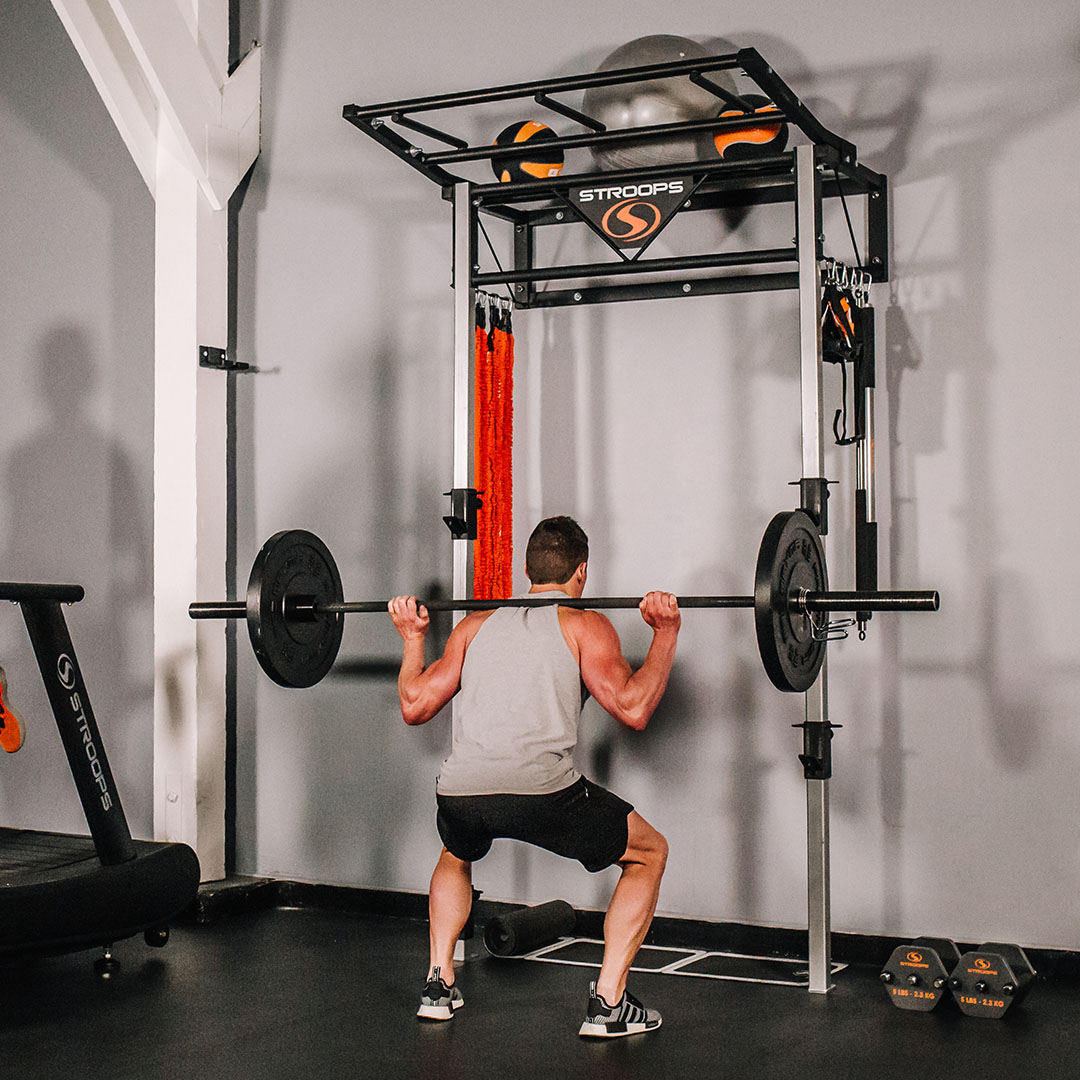 stroops athlete performing a squat on a performance station