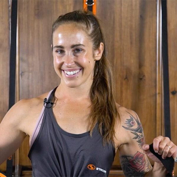 Stroops trainer Melissa smiling before Dorbarre workout