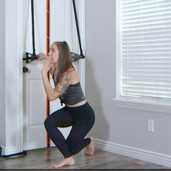 Stroops trainer Melissa doing Dorbarre reverse yogi squat leg swing
