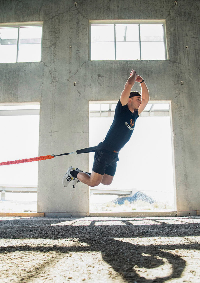 stroops coach Caysem Johnson jumping with the Power Pull Belt