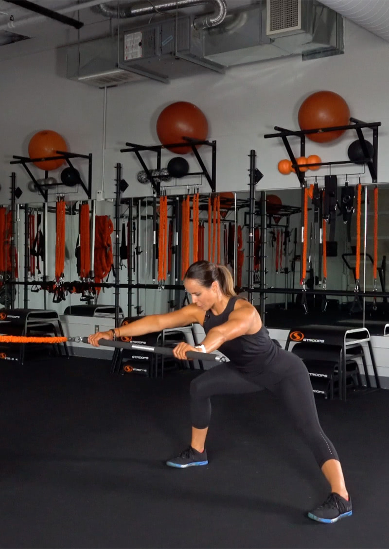 stroops coach aly purdy performing a side lunge with the fit stik pro bar