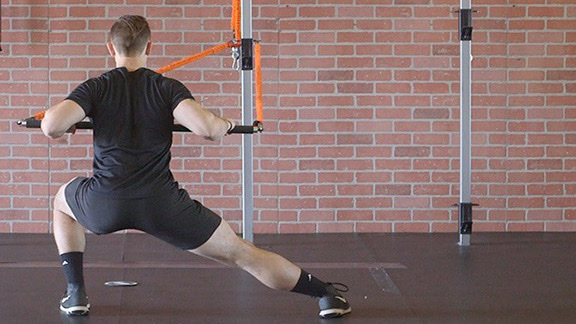 Stroops trainer Caysem performing an alternating side lunge