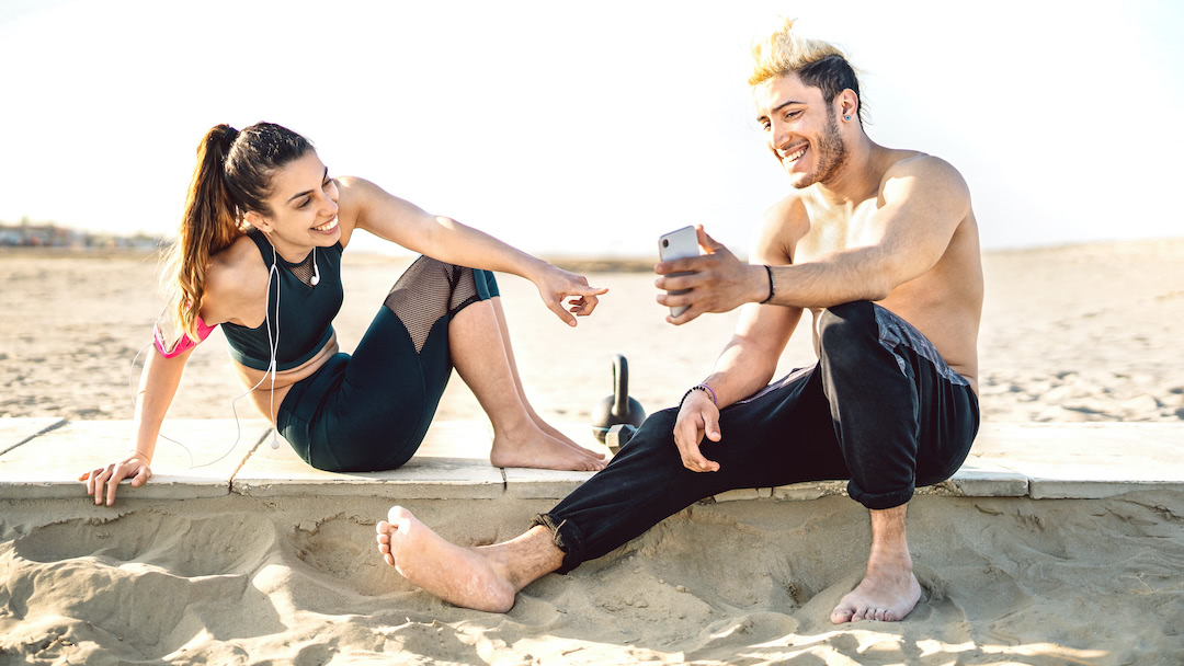 Happy couple having break at sport fitness training