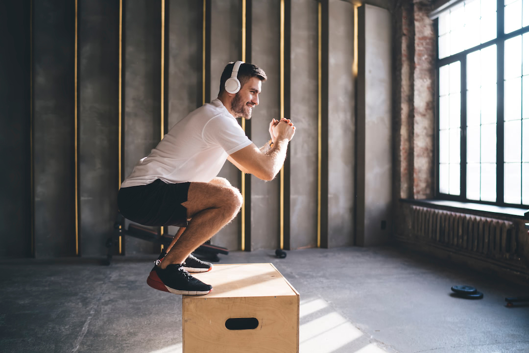 Man performing box jump with plyo box