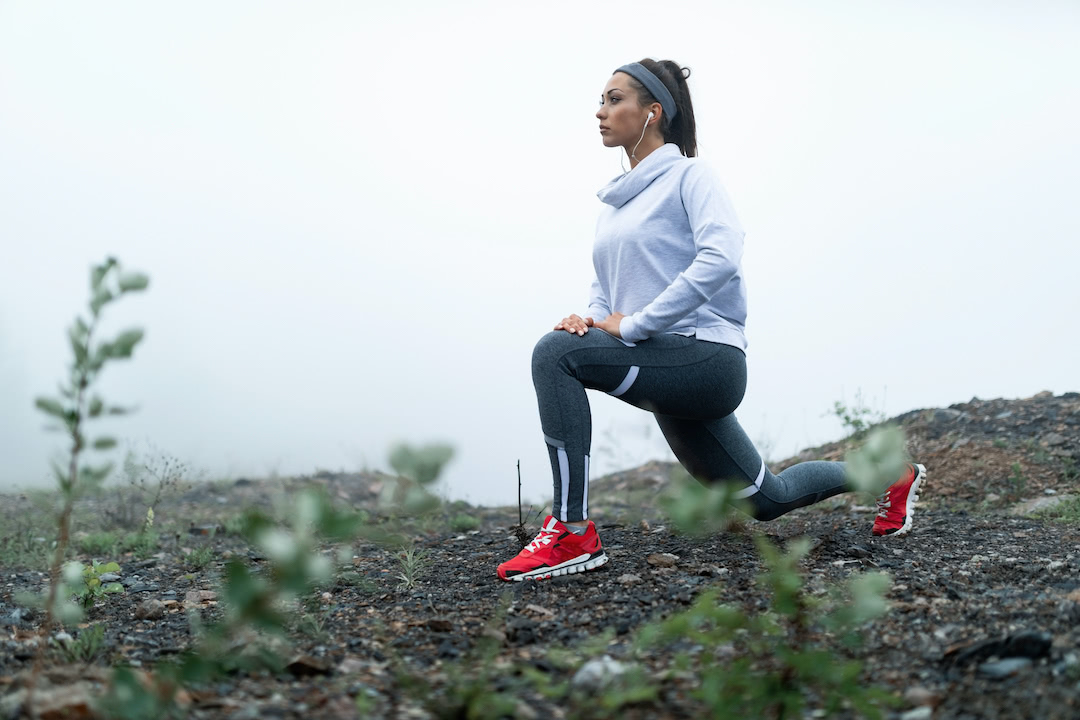 Young athletic woman doing lunges