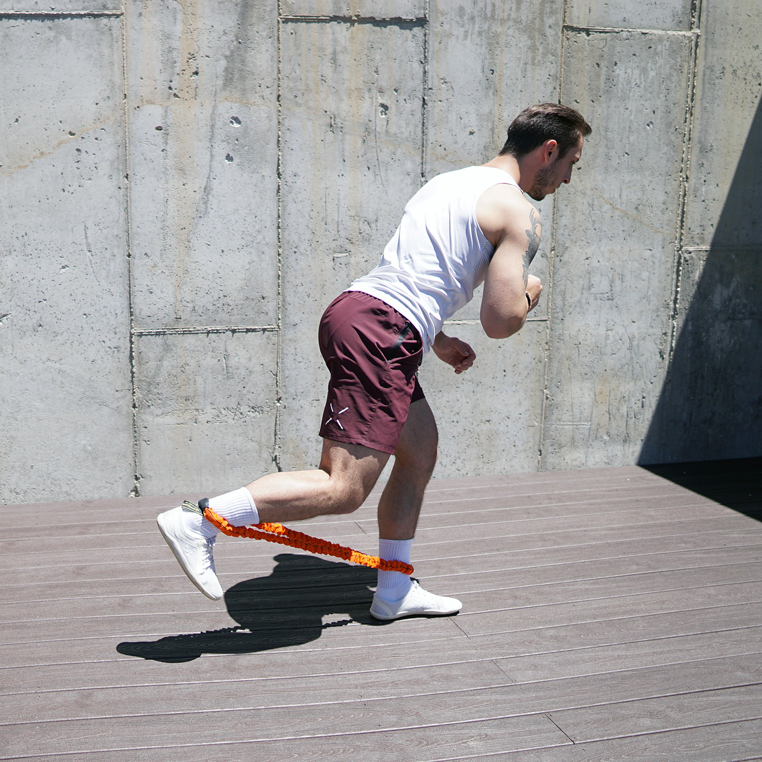 Stroops trainer Caysem Johnson doing outdoor workout with a Loop resistance band.