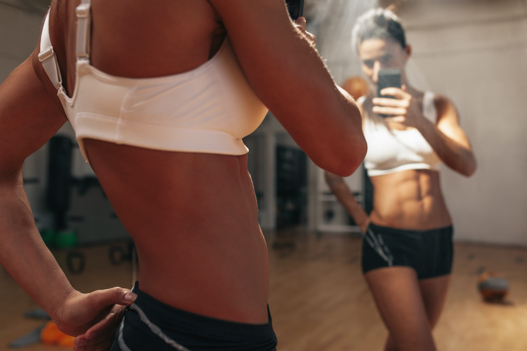 Athlete taking picture in the gym.