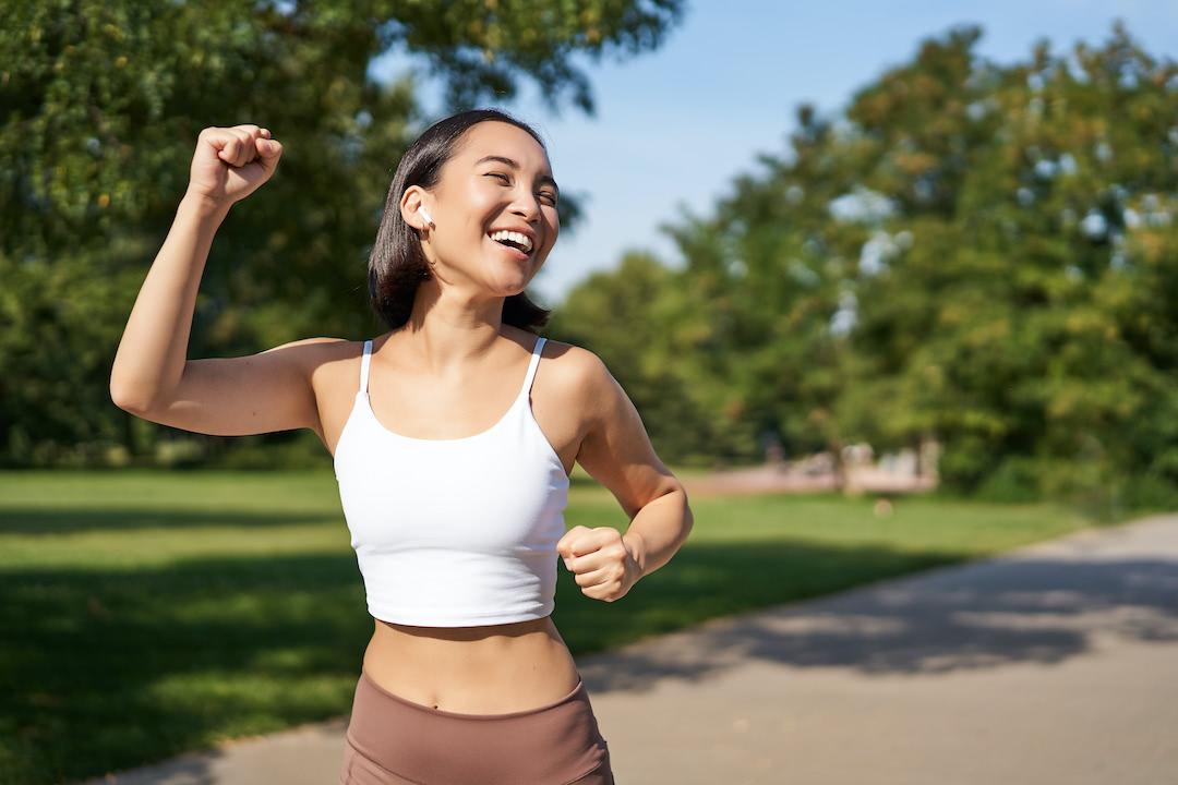 Female athlete celebrating end of workout.