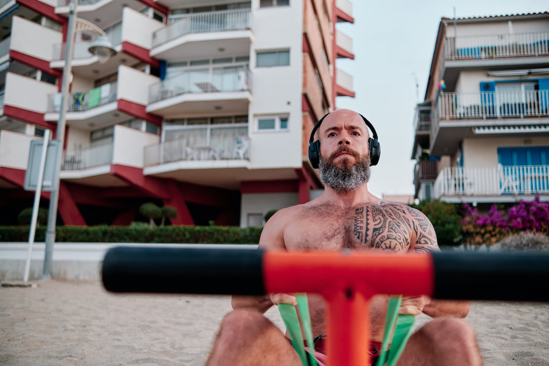 Athlete man anchors a resistance band outdoors