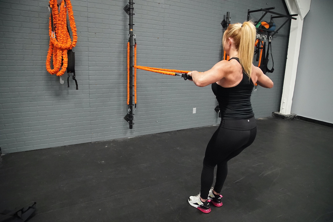 Woman using resistance bands to reduce inflammation during workout