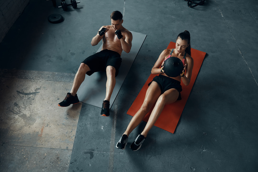 Athlete couple using exercise mats.