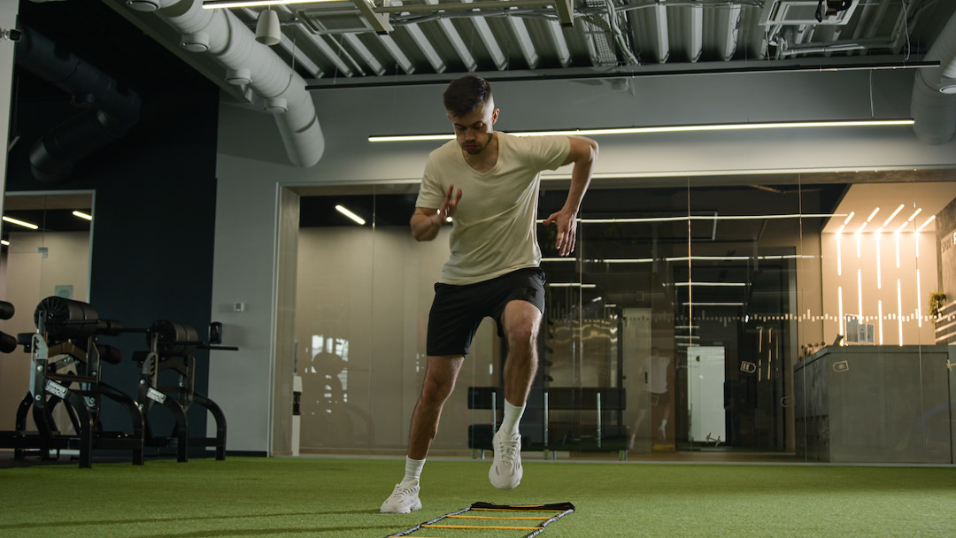 football player using agility ladder