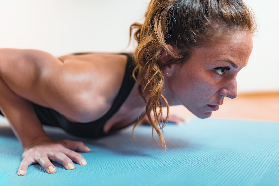 Young woman doing at-home cardio through HIIT